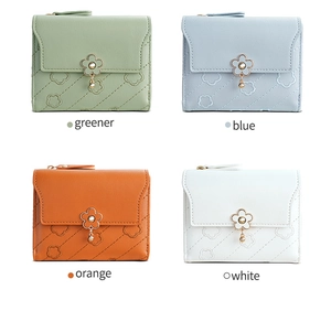 Grid view of four small leather wallets with floral clasps in green, blue, orange, and white