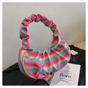 Detail view of rainbow gradient pleated shoulder bag with smooth satin texture and hobo shape