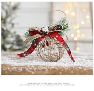 Hollow rustic Christmas ball with red tartan ribbon and pine cone on snowy wood surface