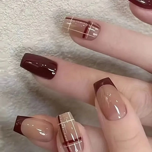 Deep burgundy and nude pink press-on nails with checkered pattern and French tips