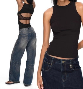 Detail of black ribbed tank top featuring lace cutout back and washed blue jeans