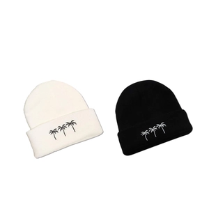 Knitted beanie hats with embroidered palm trees in black and white winter style