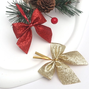 Detail of red and gold Christmas bows with glitter finish and flexible twist ties