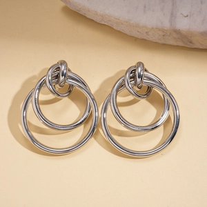 Macro detail of triple interlocking geometric silver circle earrings with polished finish