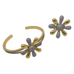 Two-tone daisy jewelry set with gold bangle and ring featuring micro-pave cubic zirconia