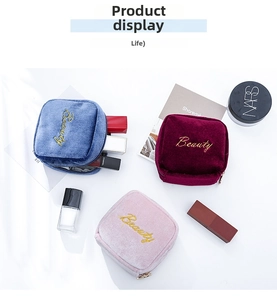 Detail view of colorful velvet cosmetic bags with Beauty embroidery and gold zippers
