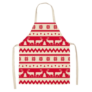 Close-up of linen Christmas apron featuring reindeer, trees and festive patterns