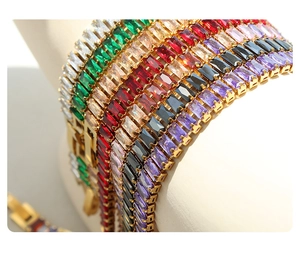 Detail of gold titanium steel bracelets with colorful rectangular zirconia inlays