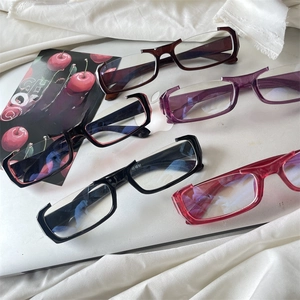 Flat lay of half-rim glasses in multiple colors with anti-radiation lenses and sleek frames