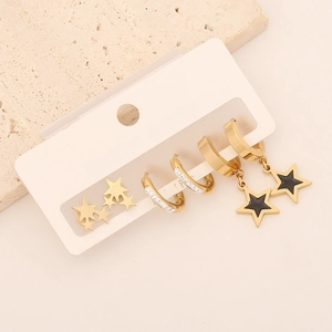 Detailed set of three gold earrings featuring stars, moons, and sparkling crystals