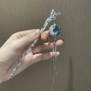 Silver hairpin with Ping An buckle and long tassel charm, hand-held shot for hair styling