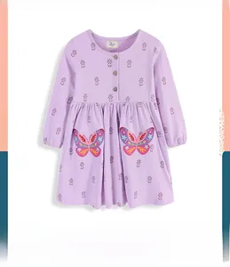 Detail of purple cotton girl dress featuring wooden buttons and floral butterfly embroidery