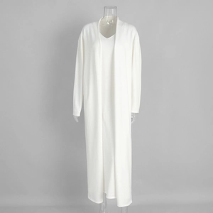 Detail of soft cream knit cardigan and V-neck maxi dress set with refined texture