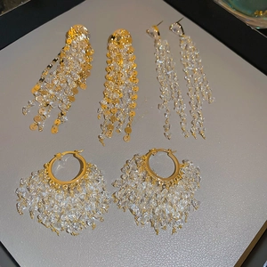Detail view of 18k gold plated tassel earrings with sparkling crystals and beads