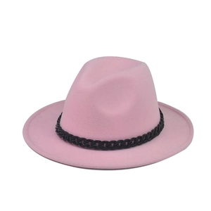 Detail of a pink fedora wool hat featuring a thick brim and a decorative black chain