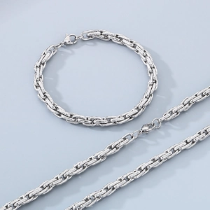 Detail view of silver textured twist chain bracelet and necklace with lobster clasp
