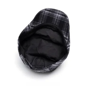 Internal view of plaid newsboy hat featuring breathable black lining and sweatband detail