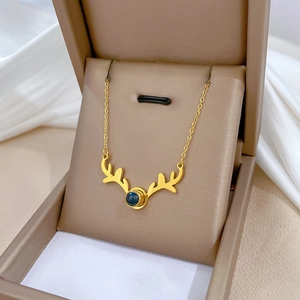 Minimalist gold deer necklace with blue stone in a premium beige jewelry gift box