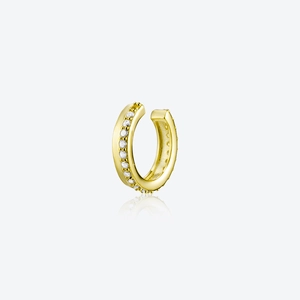 Detailed close-up of a minimalist gold ear cuff with shimmering white zircon stones
