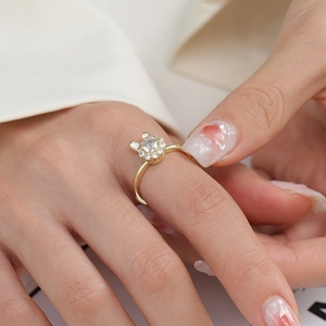 Detail view of rotating rabbit ring with sparkling zircons and white enamel ears
