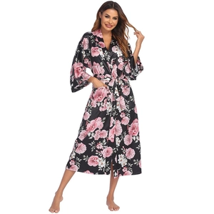 Detail view of the black floral satin robe showing the smooth texture and side pockets