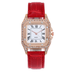 Detail of rose gold square watch with crystal bezel and red crocodile leather strap