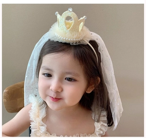 Detail of girls' crown headband featuring yellow glitter crown with stars veil