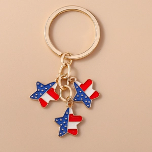 Detail of golden keychain with American flag star charms and red blue enamel finish