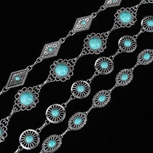 Detailed view of silver bohemian waist chains with various turquoise stone settings