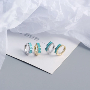 Macro detail of S925 sterling silver hoop earrings with blue rectangular zircon inlays