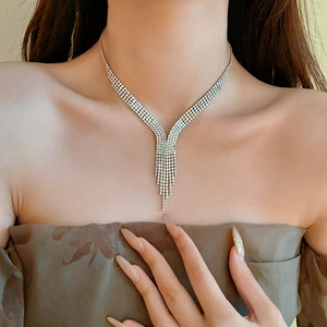 Detail of silver drop fringe necklace featuring layered rows of sparkling rhinestones