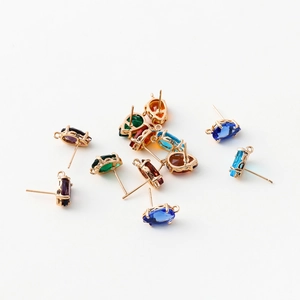 Macro shot of colorful teardrop zircon studs with 14k gold plated DIY jewelry earring bases