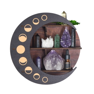 Detail of moon-shaped wooden shelf with moon phase cutouts for crystal display