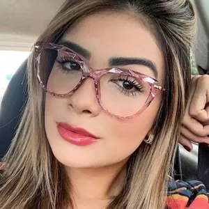 Pink cat eye glasses with faceted frame and anti-blue light lenses worn by a model