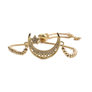 Adjustable gold star and moon bracelet with zircon stones on a white background