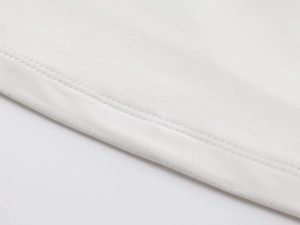 Close-up of white knitted bandeau top showing double-needle interlocking stitch detail