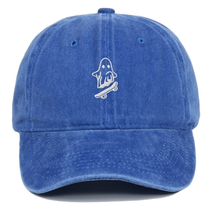 Close-up of ghost on skateboard embroidery on a vintage washed blue cotton baseball cap