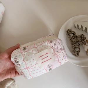 Close-up of pink quilted cotton makeup bag featuring cute bunny and floral patterns