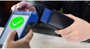 Men's leather RFID wallet with automatic slide pop-up credit cards at payment terminal