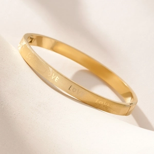 Golden titanium steel bangle with LOVE engraving and geometric mesh pattern design