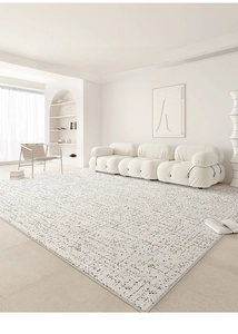 Detail of cream minimalist waterproof rug with black flecks in a modern living room