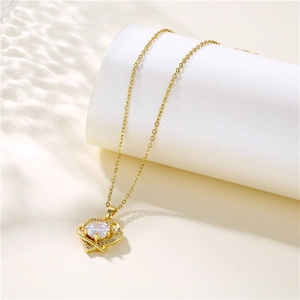 Elegant gold heart pendant necklace with shimmering zircon stones on a white stand