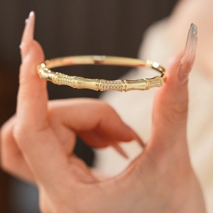 Close-up of gold-plated bamboo joint bangle with sparkling pavé cubic zirconia details