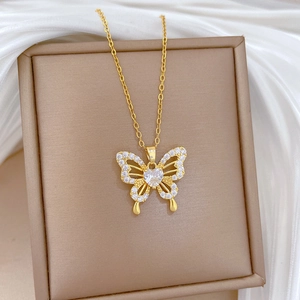 Detailed close-up of a luxury butterfly pendant with zircon crystals on a gold chain
