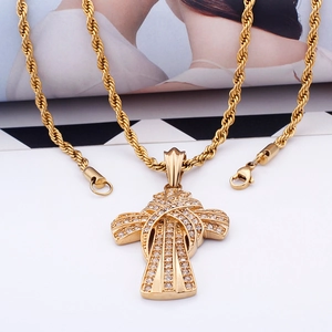 Detailed view of hip hop gold plated cross pendant with iced-out zircons on twist chain