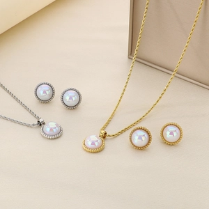 Close-up of gold and silver twisted chain necklaces with iridescent round pearl pendants
