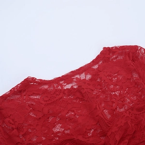Close-up of red floral lace texture on dress showing detailed mesh pattern and fabric