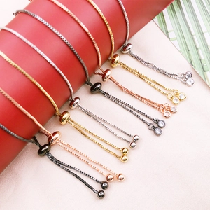 Close-up of adjustable slider bracelets in gold, silver and rose gold with zircon charms