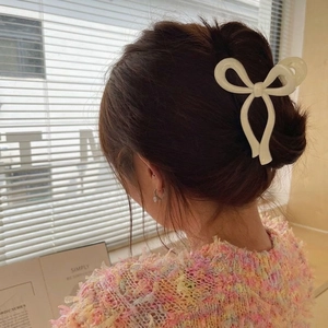 Cream jelly texture bow hair claw clip for high ponytail styling on back of head