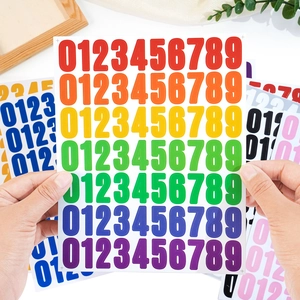 Macro shot of 1-inch rainbow vinyl number stickers 0-9 for journaling and organization